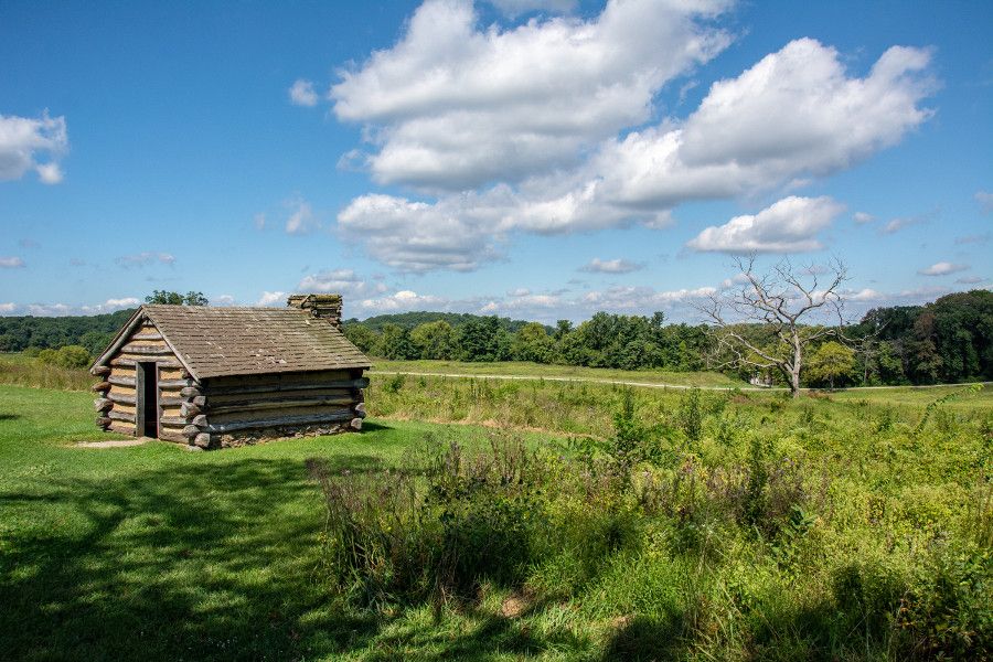 A log cabin in a meadow at Valley Forge National Historical Park.