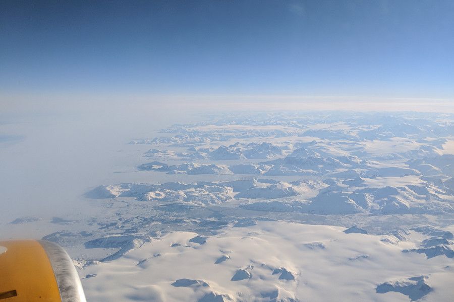 View of Greenland from the airplane window flying Icelandair.