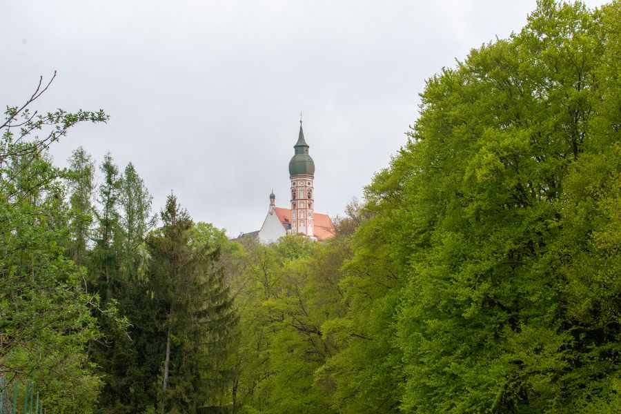 The Andechs church steeple peeks out over the treetops.