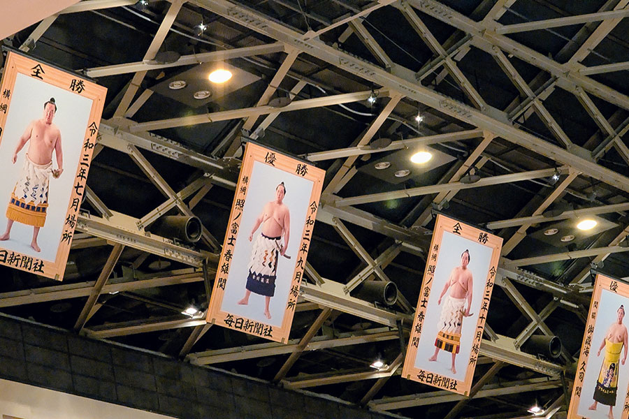 Banners of top sumo rikishi, like former Yokozuna Hakuho, hang from the rafters of Ryogoku Kokugikan in Tokyo.