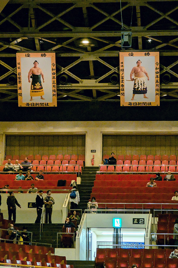 Banners of top sumo rikishi hang from the rafters above the second floor chair seating of Ryogoku Kokugikan in Tokyo.