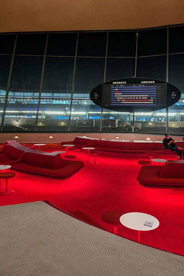 Relaxing in the retro-chic Sunken Lounge with its decorative departure board at the TWA Hotel