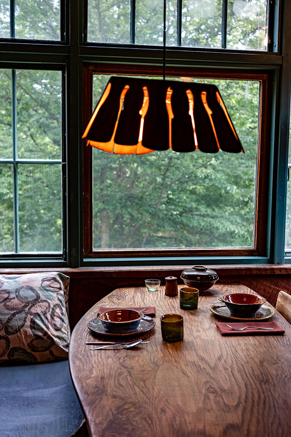 Dining nook inside the Wharton Esherick House with handcrafted wooden table, pottery, and custom lighting design at the Wharton Esherick Museum.
