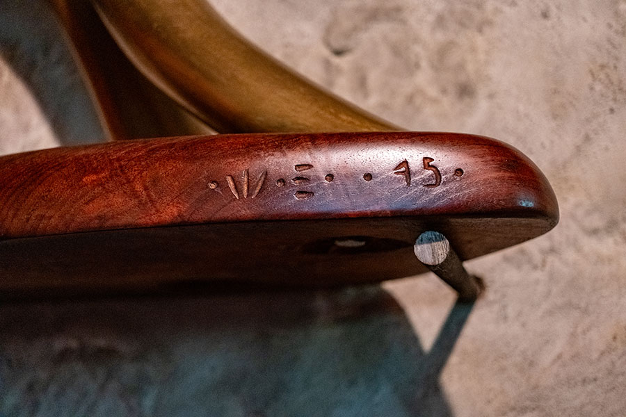 Detail of Wharton Esherick's hand-carved signature markings on a custom wooden chair at the Wharton Esherick House.