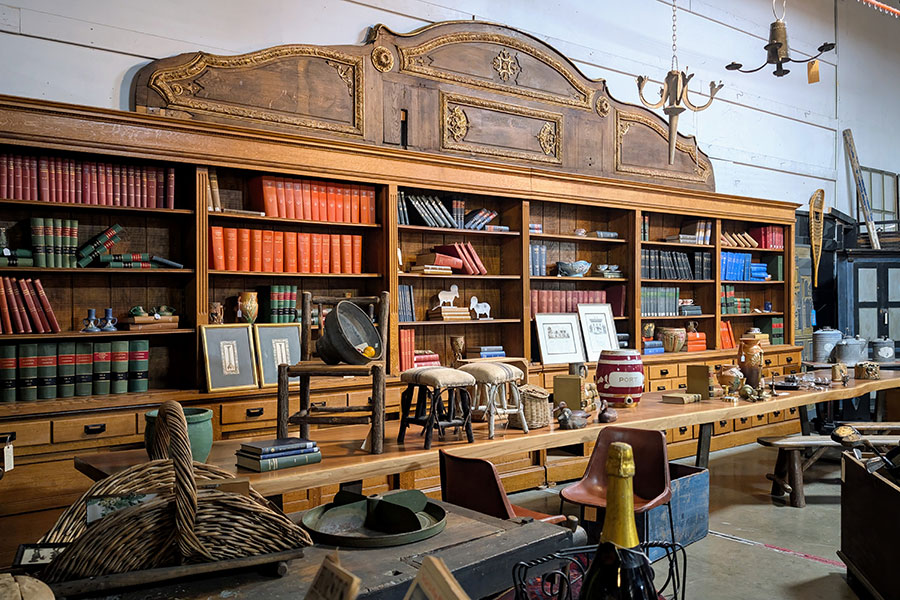 Interior of The Antique Warehouse, a large antique warehouse in Hudson, NY, filled with vintage furniture and home decor.