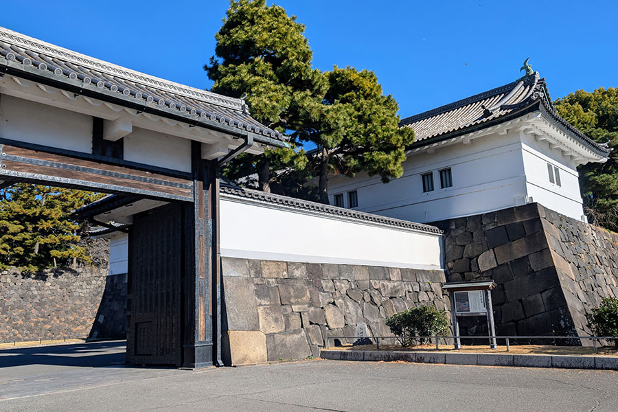 The historic Sakuradamon Gate at the Tokyo Imperial Palace, showing the outer gate and the larger Yagura-mon gatehouse set into massive stone walls.