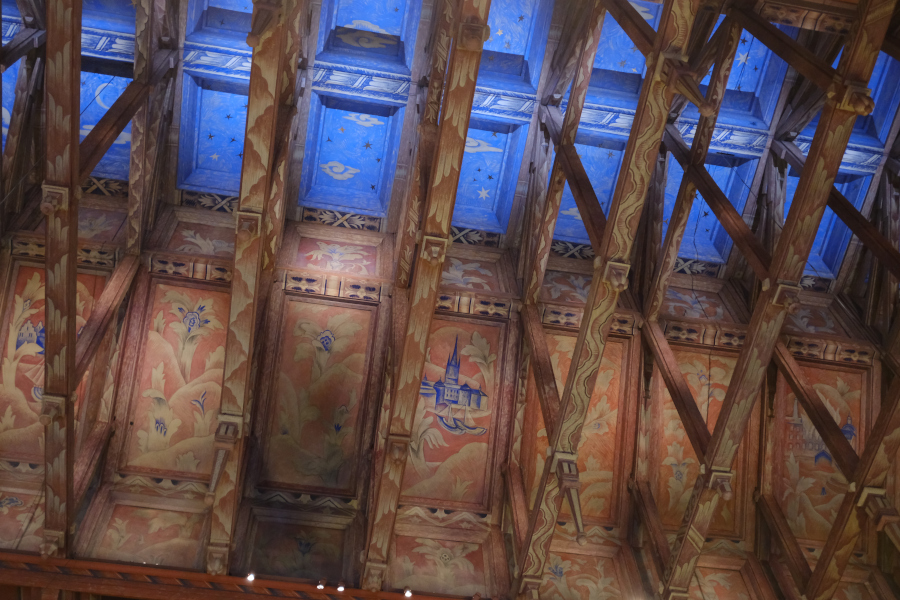 Detailed view of the intricate, Viking-inspired painted wooden ceiling beams in the Council Chamber of the Stockholm City Hall.