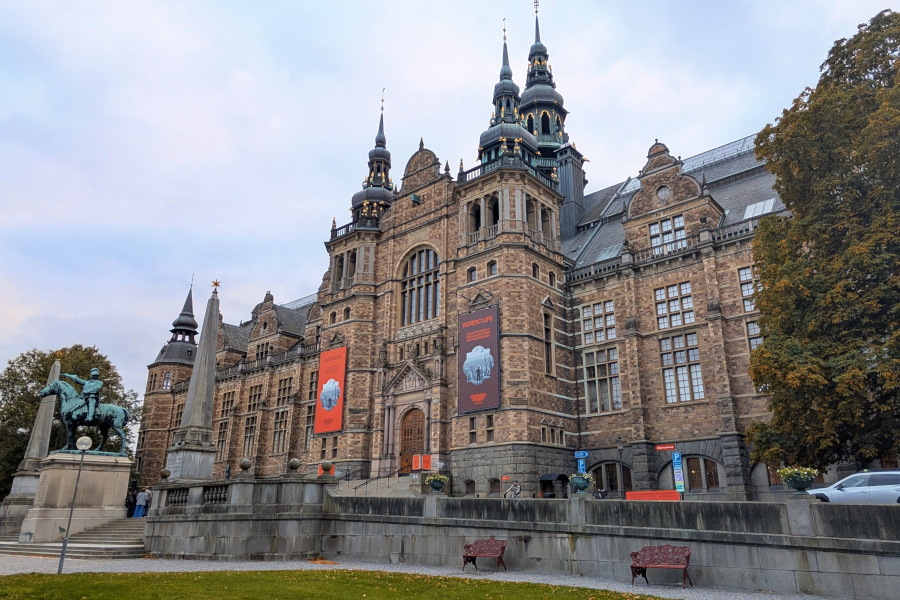 The grand neo-Renaissance architecture of the Nordic Museum in Stockholm's Djurgården district, framed by autumn trees in October.