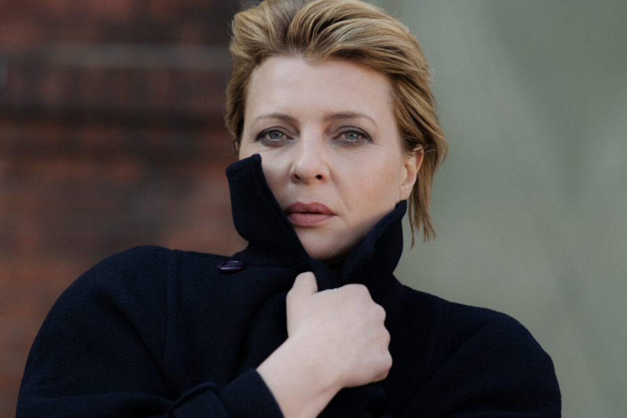 German actress Jördis Triebel, known for "Dark" and "Babylon Berlin," posing for a German language learning film feature.