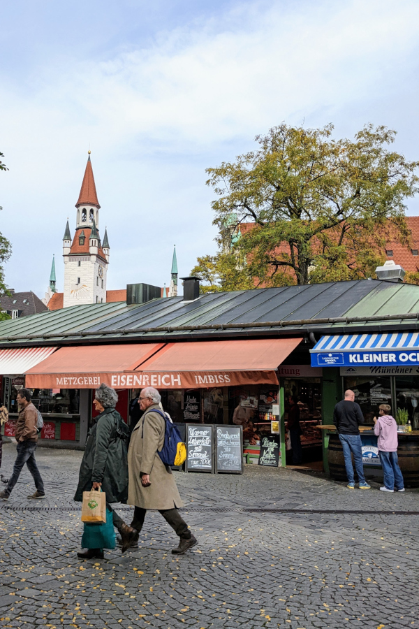 Visitors walking through Viktualienmarkt in Munich's Altstadt-Lehel neighborhood